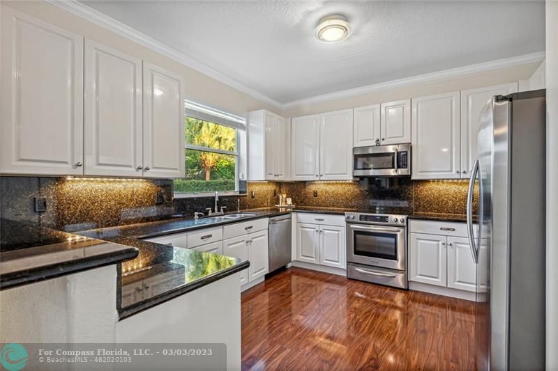 4290 Diamond Drive Weston, FL 33331 - Photo 9 of 26 a kitchen with stainless steel appliances granite countertop a stove a sink and a microwave