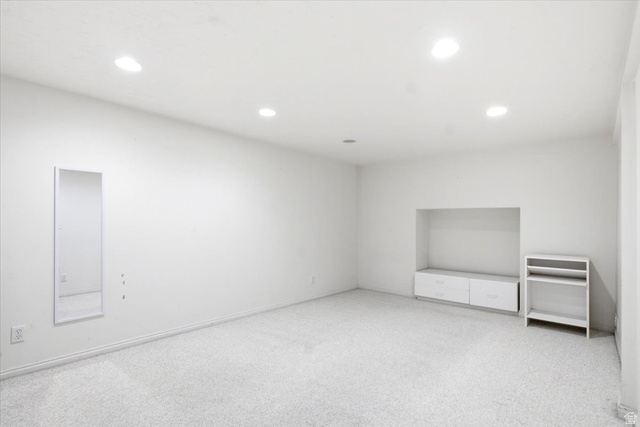 7050 South 260 East Midvale, UT 84047 - Photo 21 of 28 Spacious room featuring light-colored carpeting, recessed lighting, and a built-in media niche with integrated cabinetry