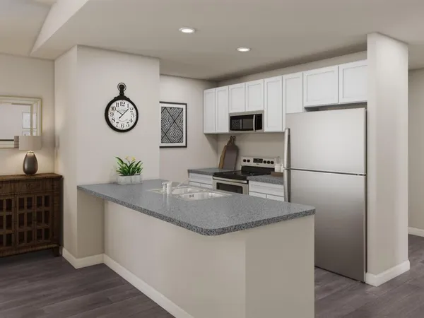 a kitchen with a refrigerator and a stove top oven
