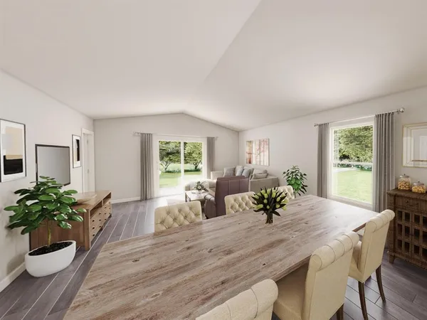 a view of a dining room with furniture and a potted plant