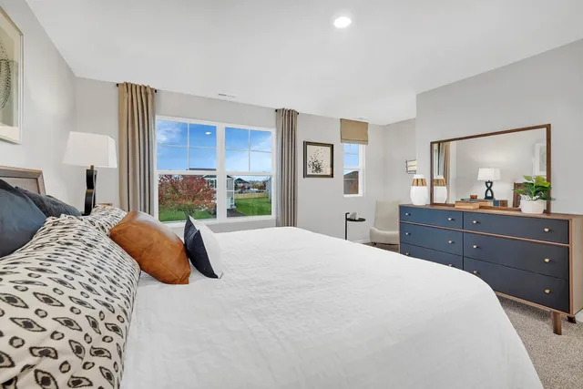 a bedroom with a bed and a dresser