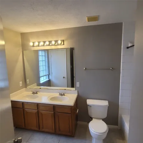 a view of an empty room with window and fireplace