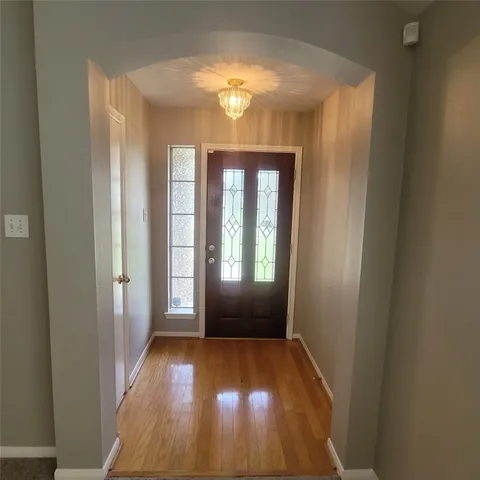 an empty room with windows fireplace and fans