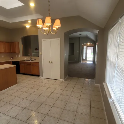 a view of a kitchen with a sink and cabinets