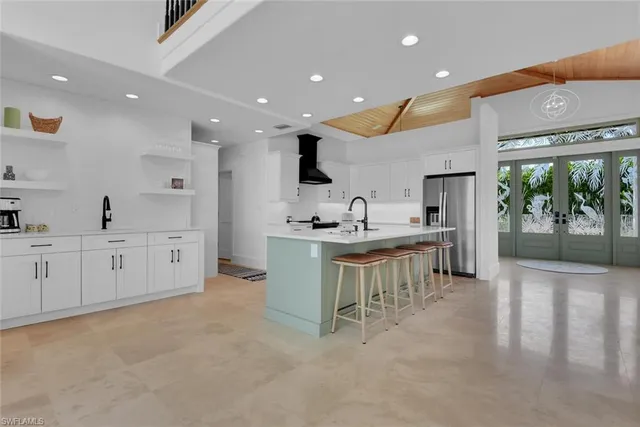 a kitchen with white cabinets and sink