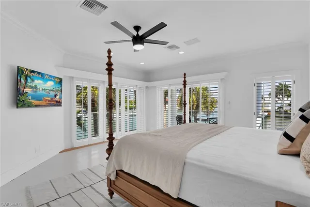 a spacious bedroom with a large bed and a large window