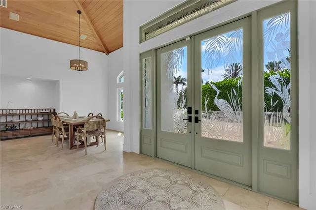 a dining room with furniture and a potted plant