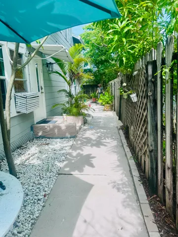 a backyard of a house with table and chairs