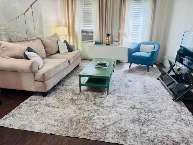 a living room with furniture and a large window