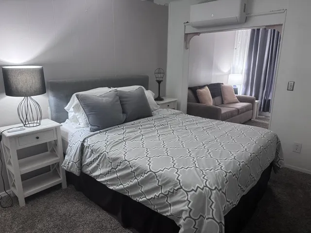 a large bed sitting in a bedroom next to a lamp