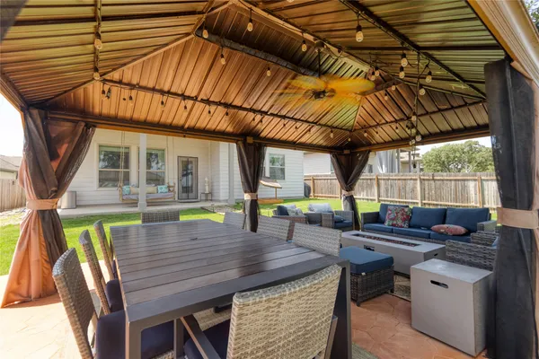 a view of deck with table and chairs