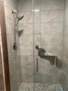 a bedroom with a bed and a ceiling fan