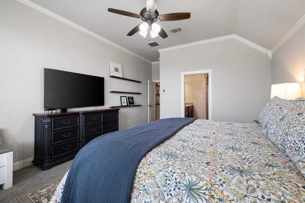 2103 Cash Point Court Granbury, TX 76049 - Photo 16 of 38 a bedroom with a bed and a flat screen tv