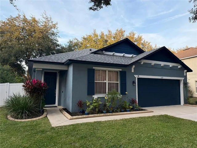 a front view of a house with a garden and yard