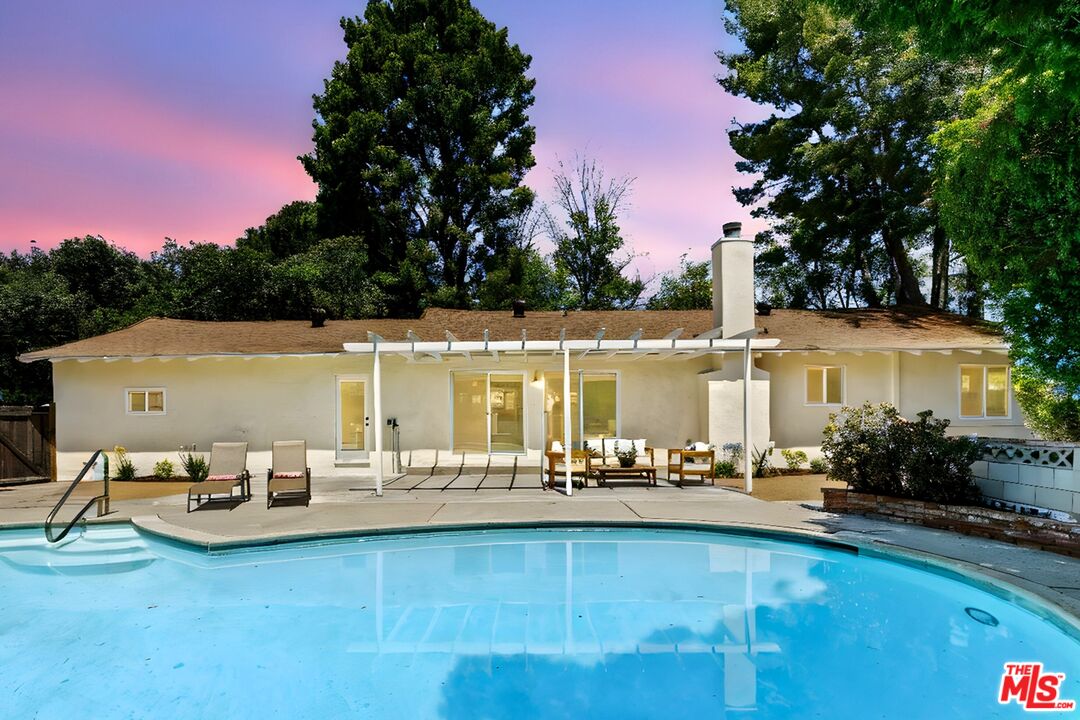 a view of a swimming pool with outdoor seating