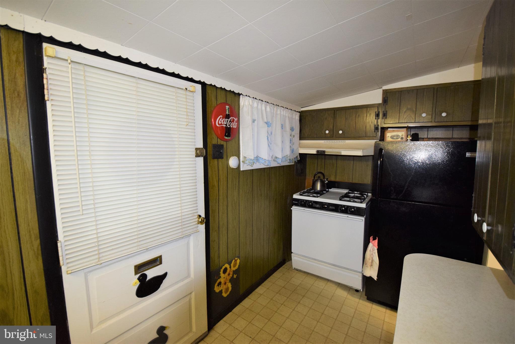 468 Peach Bottom Road Delta, PA 17314 - Photo 8 of 47 Back door entrance to kitchen-stove & refrigerator