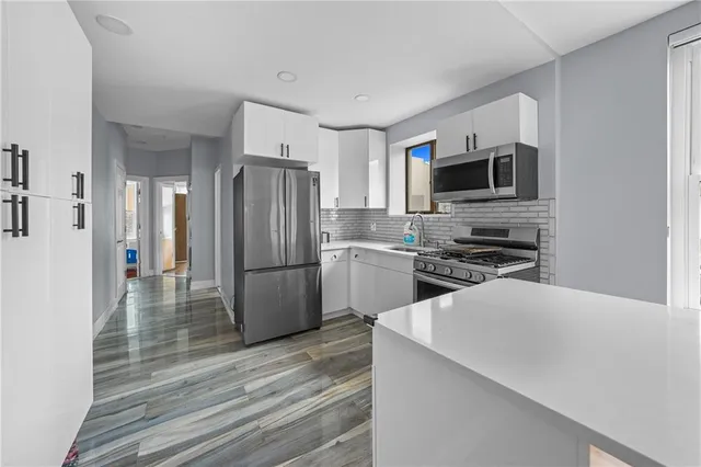 a kitchen with stainless steel appliances a refrigerator stove and microwave