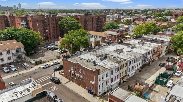 an aerial view of a house with a mountain