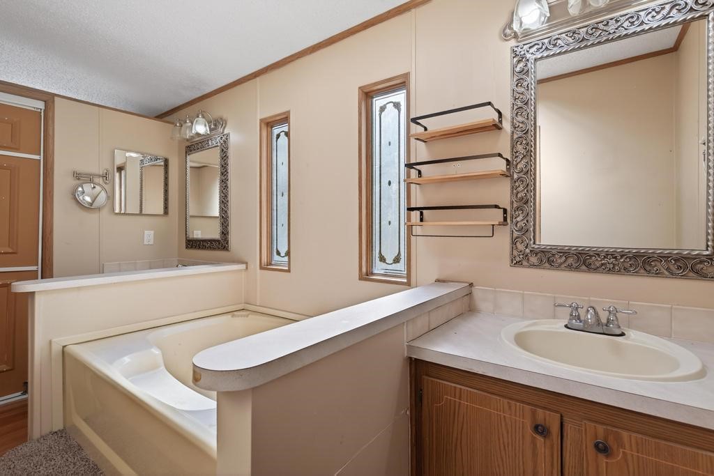 2744 Roy Sikes Road Hilliard, FL 32046 - Photo 58 of 97 a bathroom with a sink and a mirror