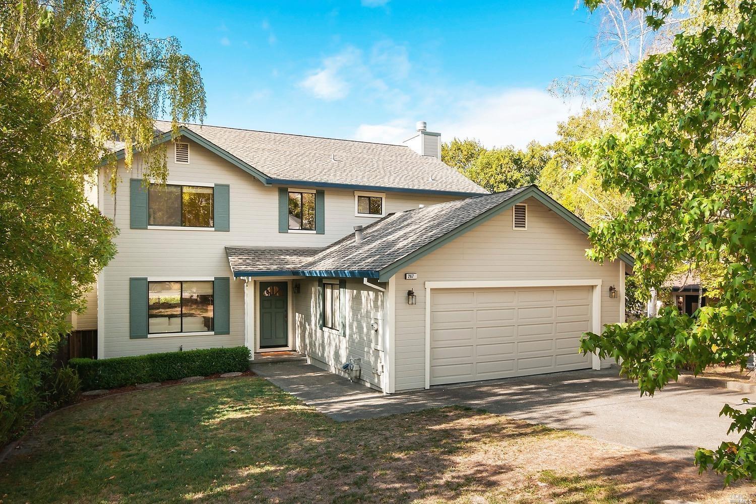 a front view of a house with a yard and garage