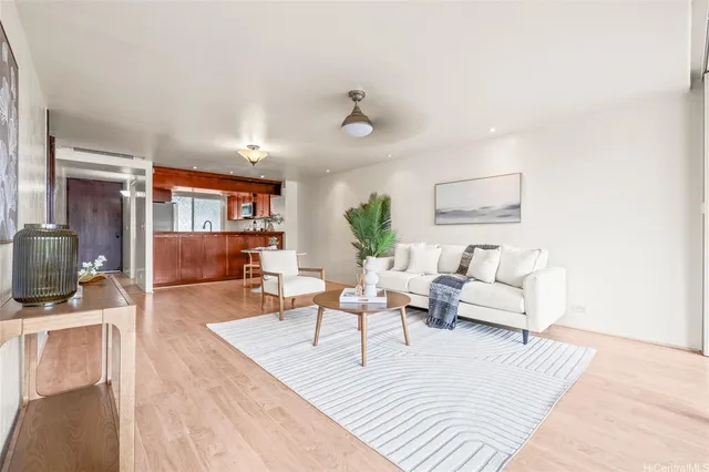 a living room with furniture and a wooden floor