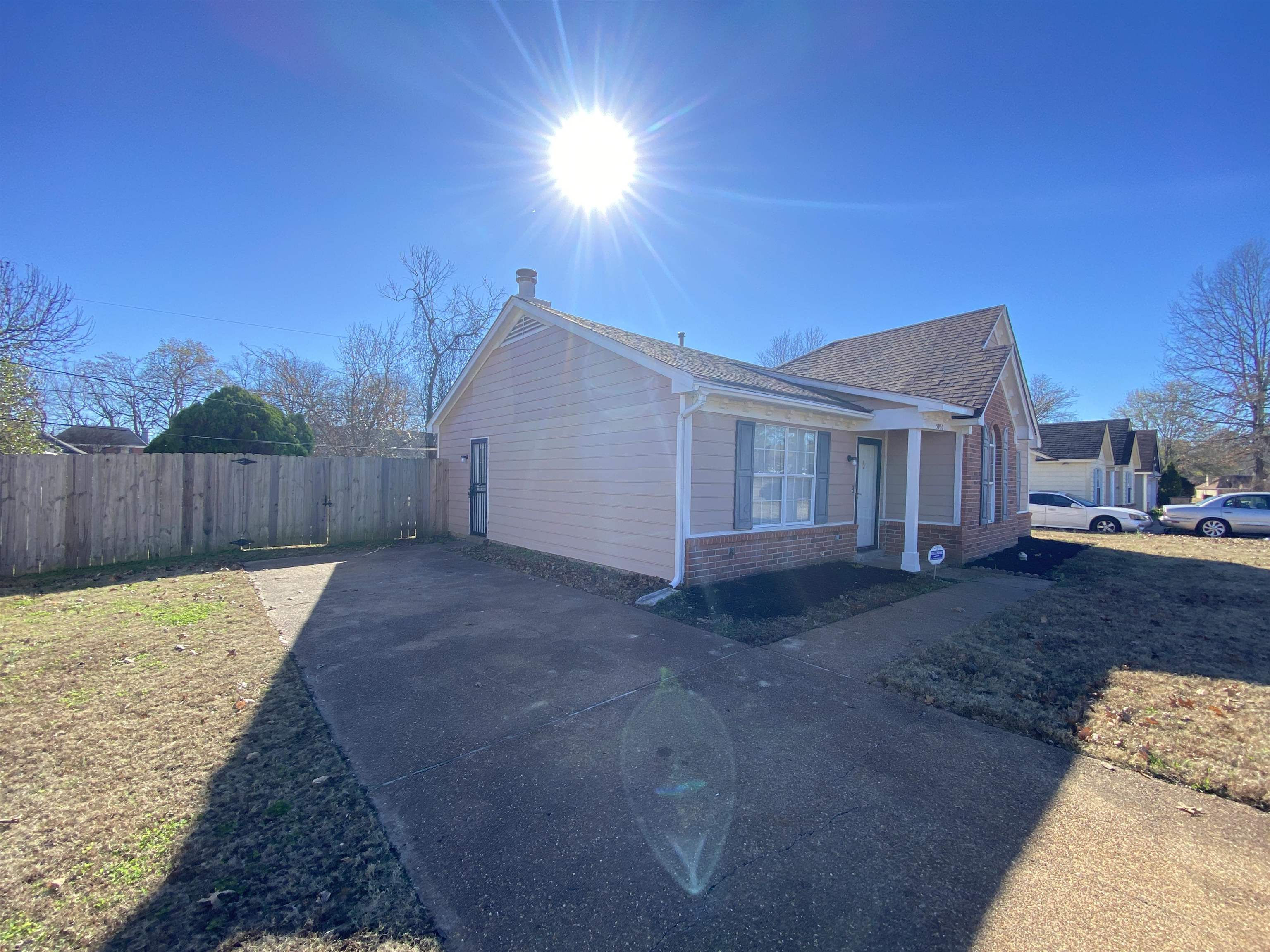 5950 Chadwell Road Millington, TN 38053 - Photo 12 of 14 View of property exterior featuring brick siding, concrete driveway, and a shingled roof