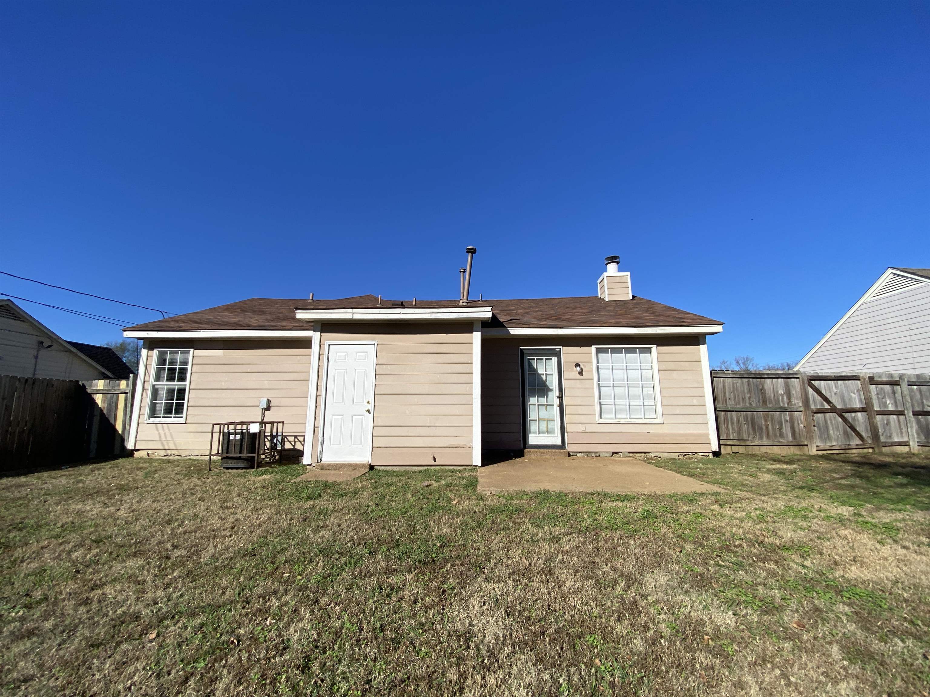 5950 Chadwell Road Millington, TN 38053 - Photo 13 of 14 Back of property with a patio area, a fenced backyard, a chimney, and roof with shingles