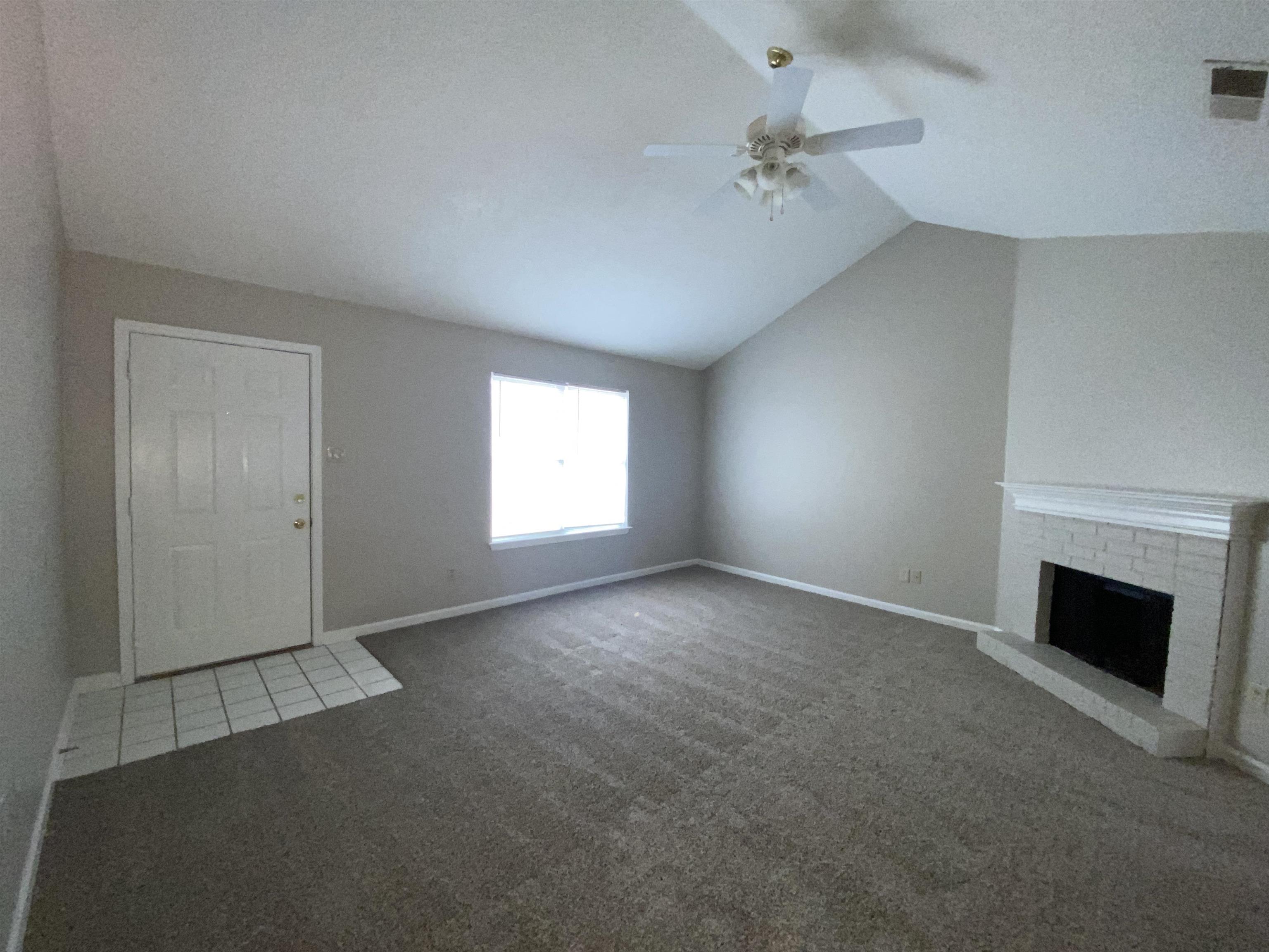 5950 Chadwell Road Millington, TN 38053 - Photo 5 of 14 Unfurnished living room with a ceiling fan, a brick fireplace, and carpet