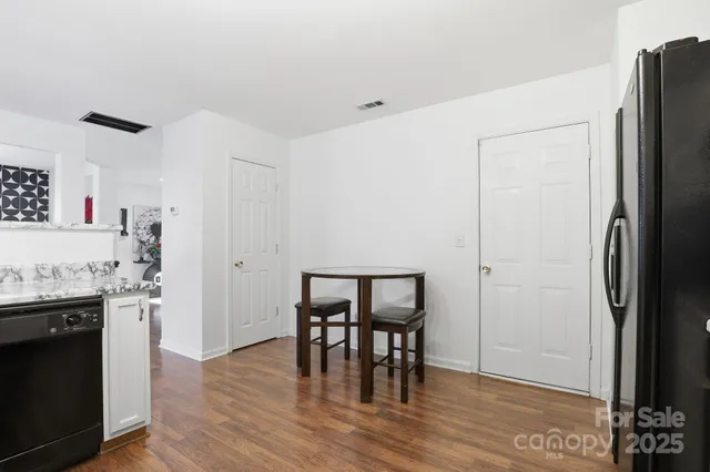 a view of a kitchen with furniture and wooden floor
