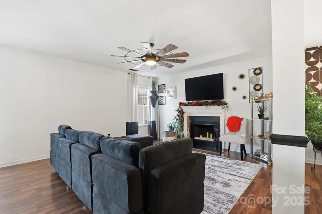 a living room with furniture a fireplace and a flat screen tv