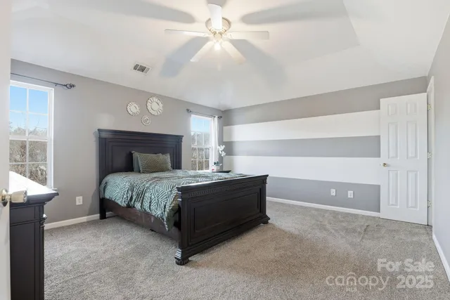 a spacious bathroom with a double vanity sink a mirror and a bathtub