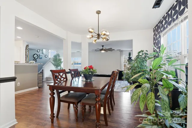 a view of a dining room with furniture wooden floor and chandelier