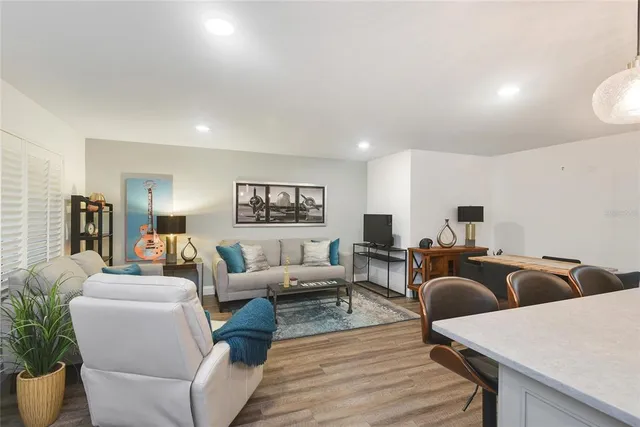 a living room with furniture a couch and a bookshelf