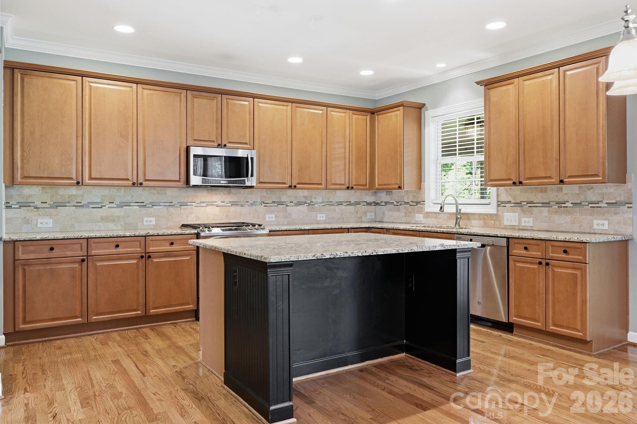 3308 Grandeur Road Charlotte, NC 28269 - Photo 13 of 45 a kitchen with stainless steel appliances granite countertop a stove a sink and a microwave