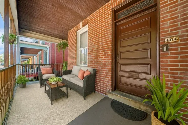 a balcony with furniture and a potted plant