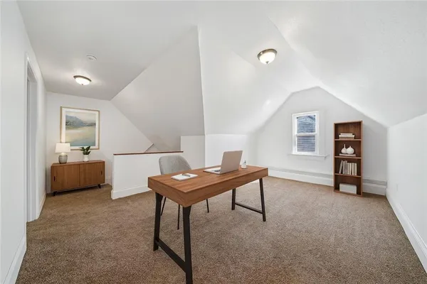 a view of a livingroom with furniture and a table in a room