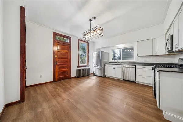 a view of a kitchen with a sink cabinet a kitchen and a window