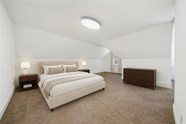 a spacious bedroom with a bed and cabinet