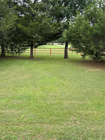 a view of a room with furniture and wooden floor
