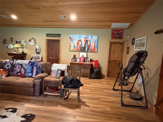 a living room with furniture a large window with kitchen view