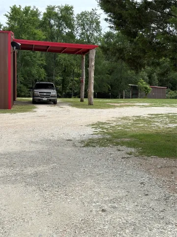 a view of a chair and table in the garden