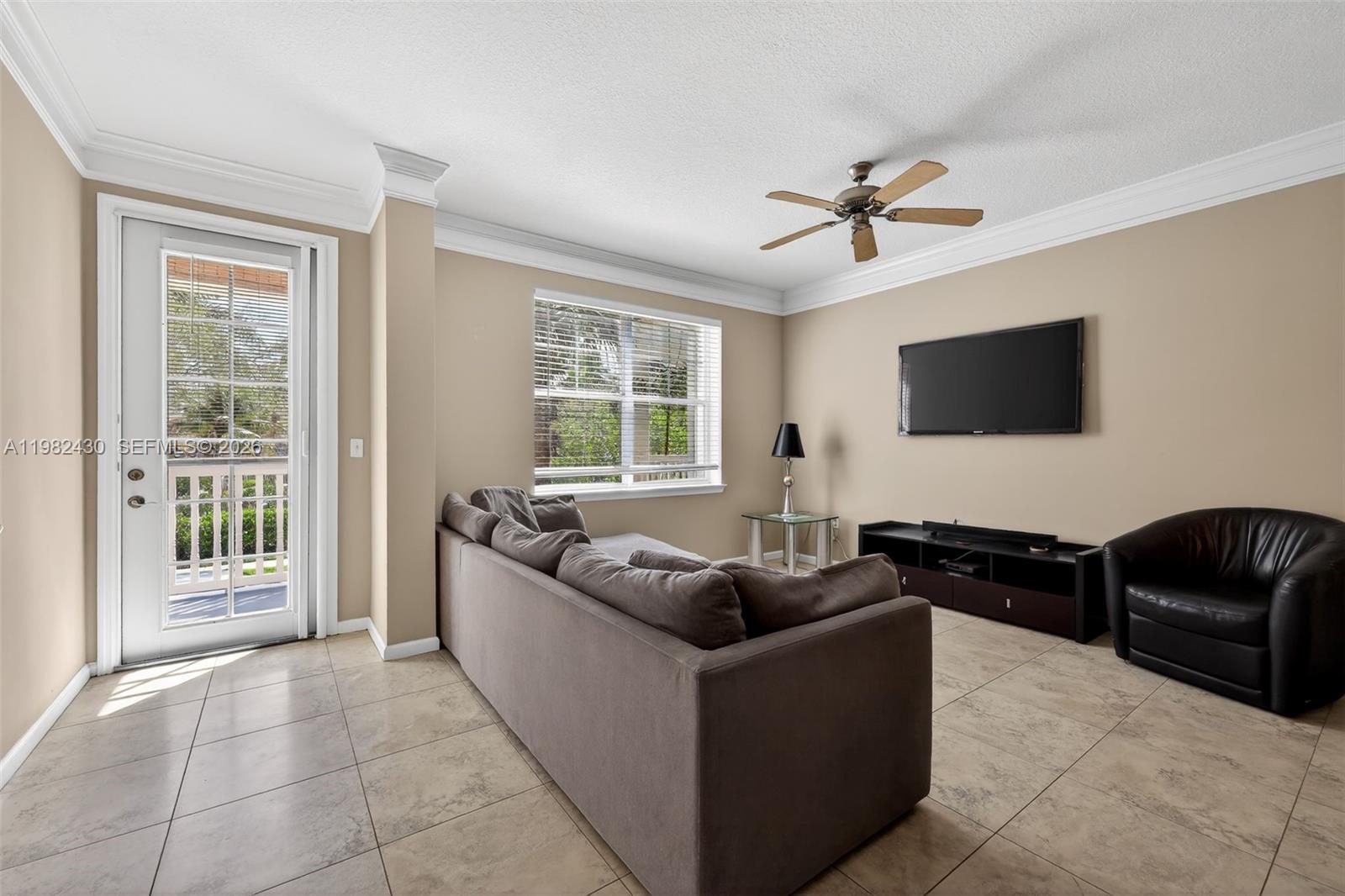 156 Aragon Way, Unit 103 Jupiter, FL 33458 - Photo 8 of 30 a living room with furniture and a flat screen tv