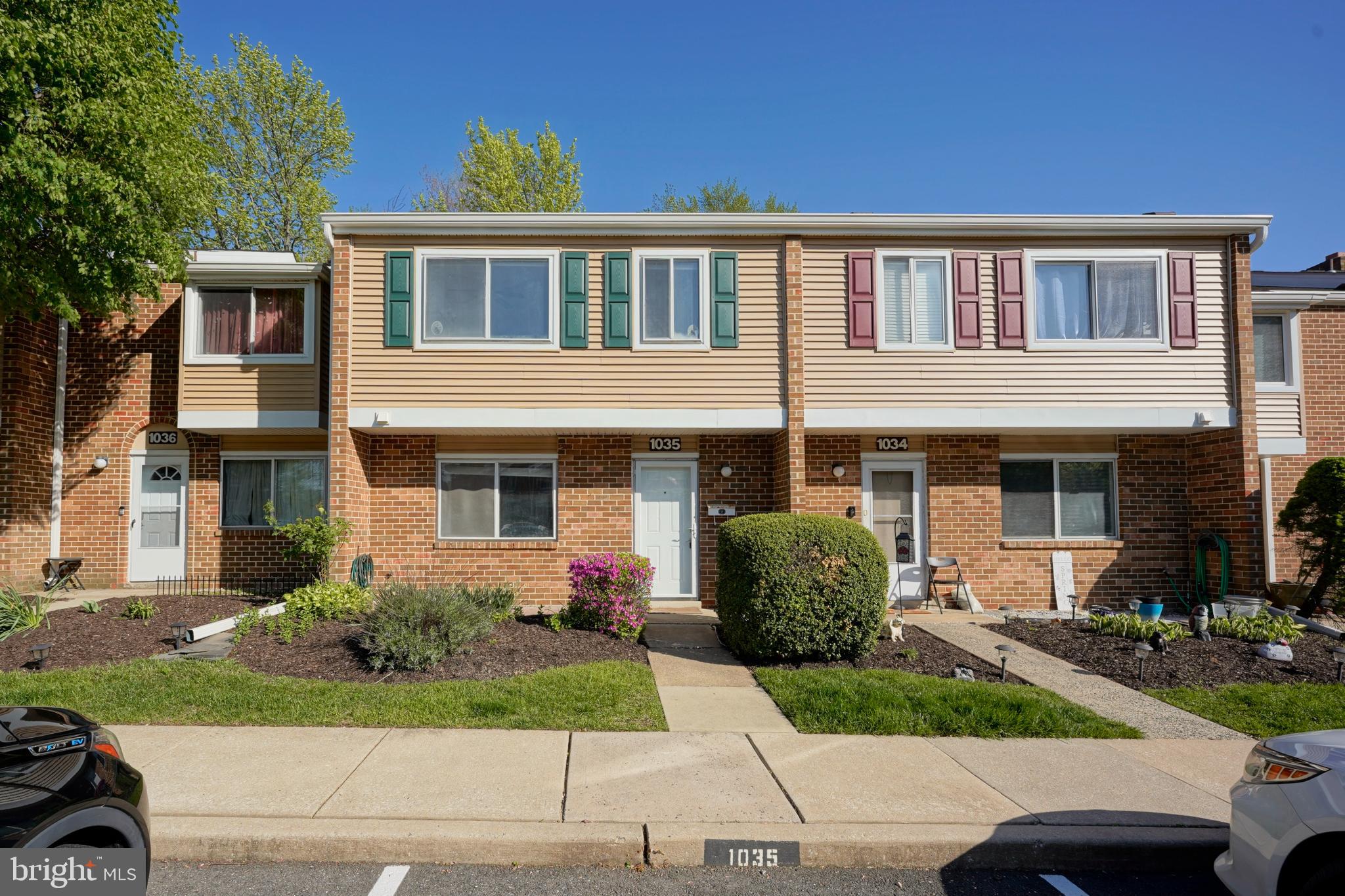 a front view of a house with garden and plants