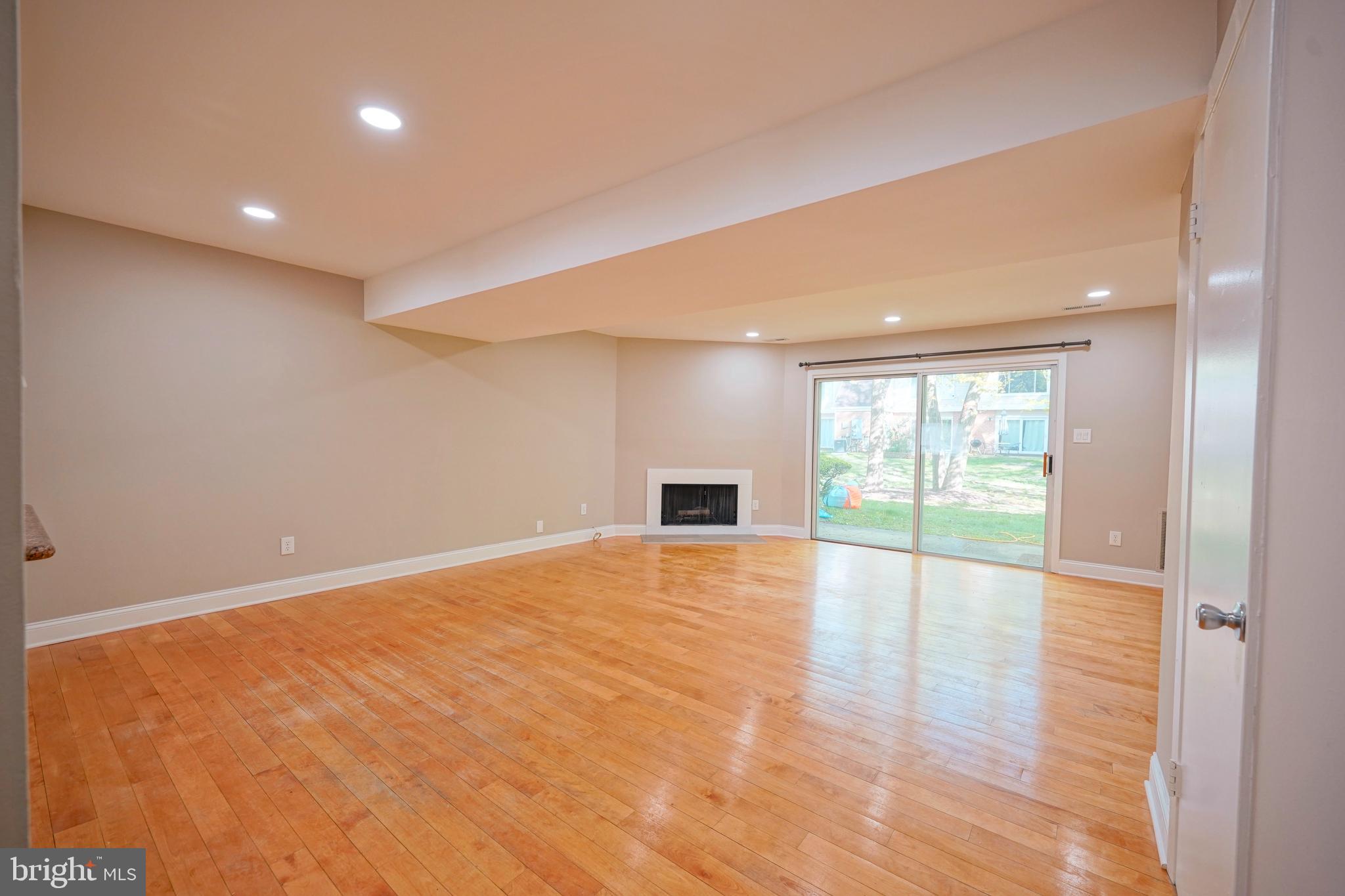 1035 Pendleton Court Voorhees, NJ 08043 - Photo 11 of 29 a view of an empty room with wooden floor and a window
