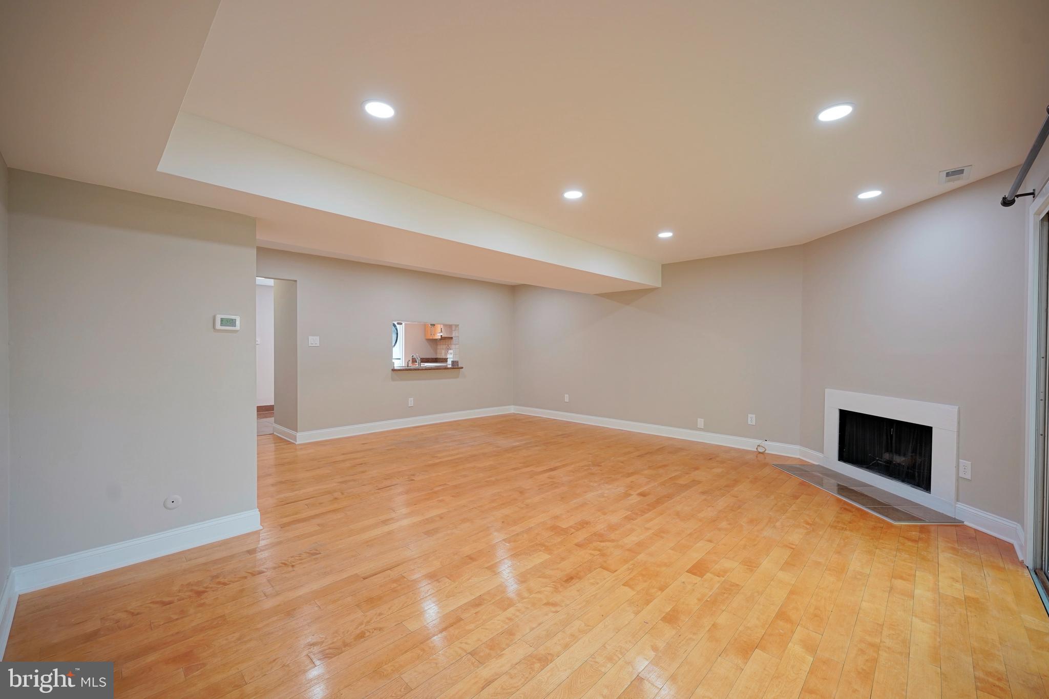 1035 Pendleton Court Voorhees, NJ 08043 - Photo 13 of 29 a view of empty room with wooden floor and fireplace