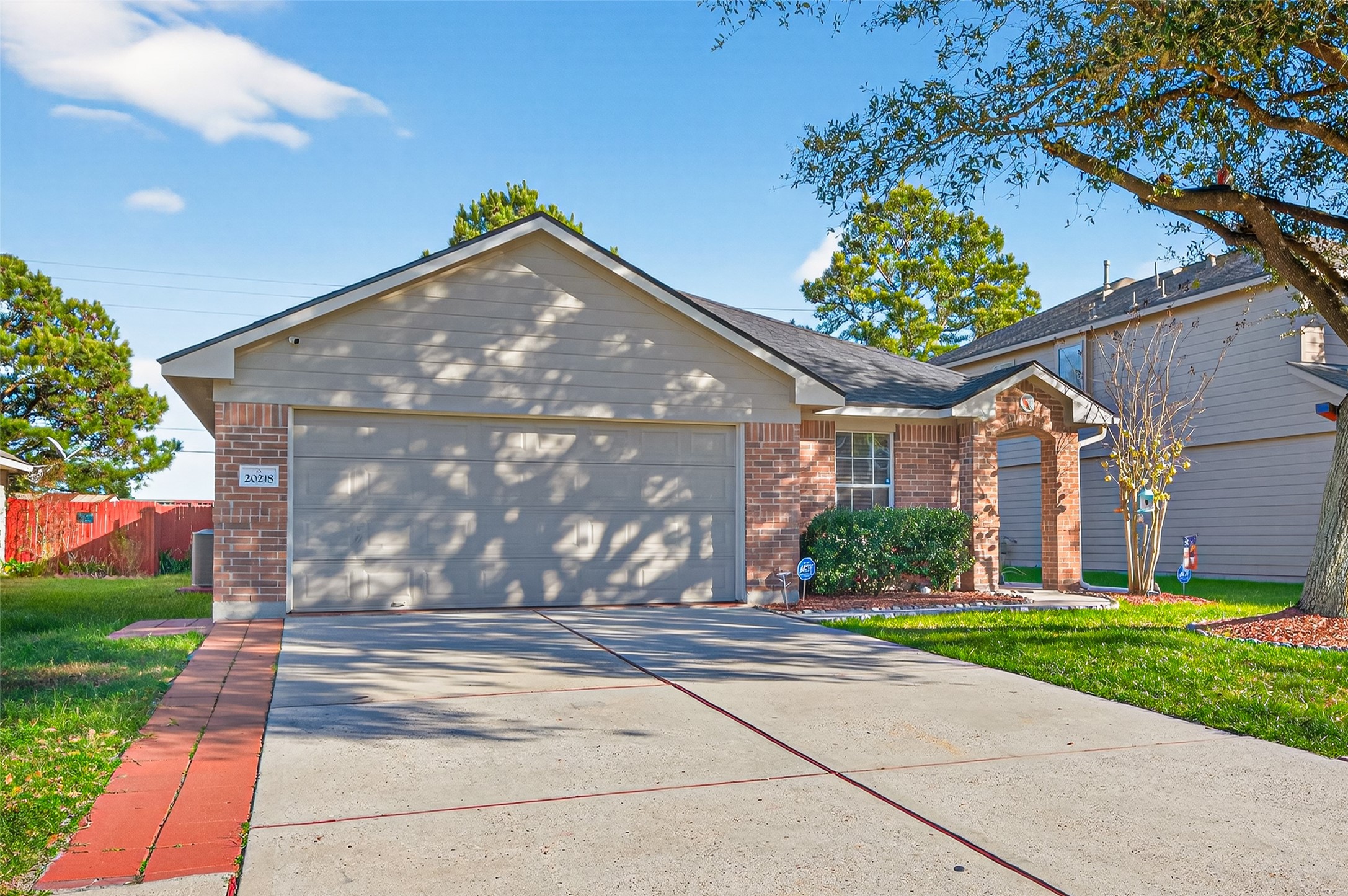 20218 Appaloosa Ridge Drive Humble, TX 77338 - Photo 2 of 44 This charming single-story home features a brick and siding exterior with a two-car garage. It’s surrounded by well-maintained landscaping, a spacious driveway, and a welcoming front entrance. Perfect for a comfortable suburban lifestyle.