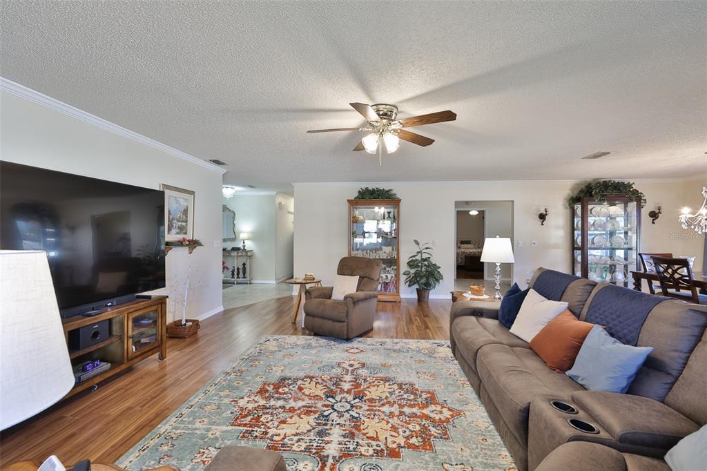 1806 Wedge Court Sun City Center, FL 33573 - Photo 12 of 53 a living room with furniture a wooden floor and a flat screen tv