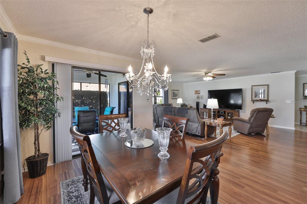 1806 Wedge Court Sun City Center, FL 33573 - Photo 16 of 53 a view of a dining room with furniture window and wooden floor