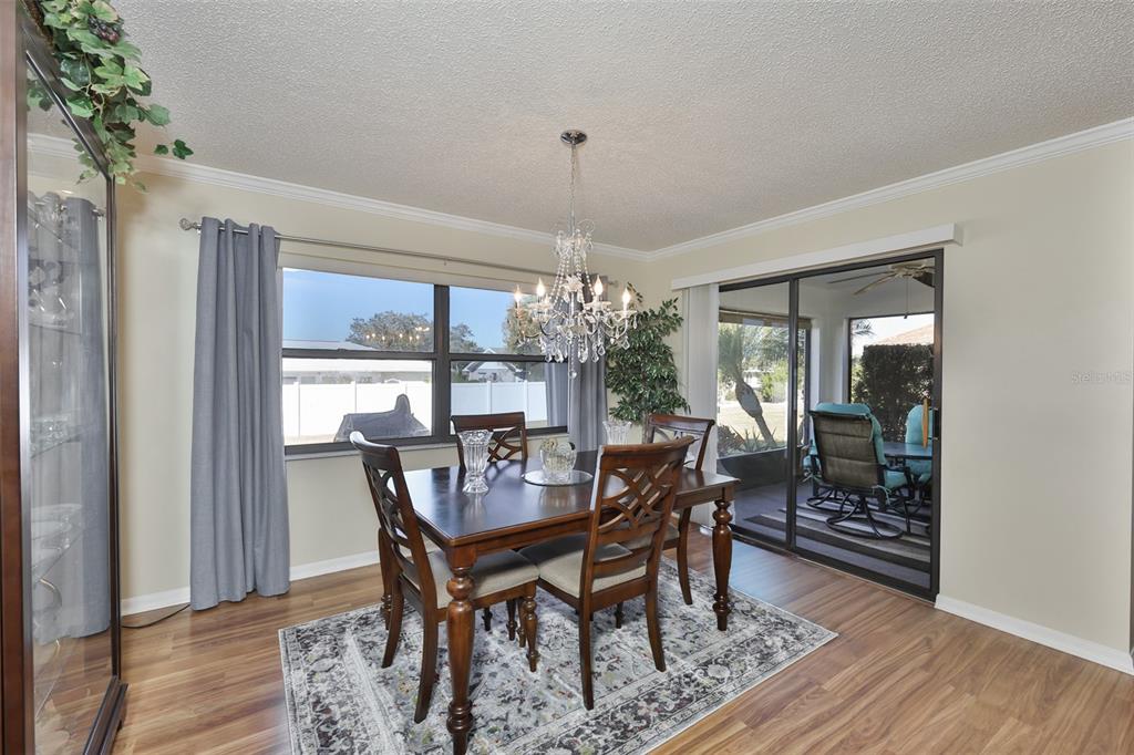 1806 Wedge Court Sun City Center, FL 33573 - Photo 17 of 53 a view of a dining room with furniture window and wooden floor