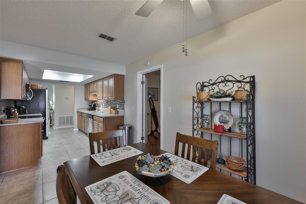 1806 Wedge Court Sun City Center, FL 33573 - Photo 23 of 53 a living room with furniture and a kitchen view
